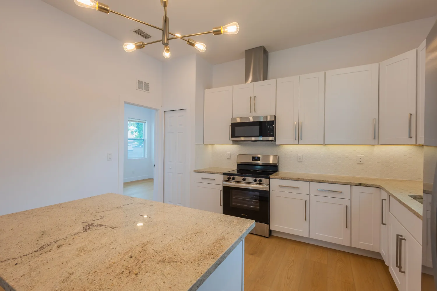 White kitchen with stainless steel appliances