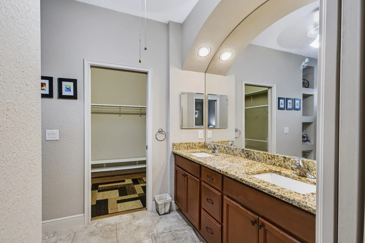 Clean double bathroom vanity with mirrors and even lighting