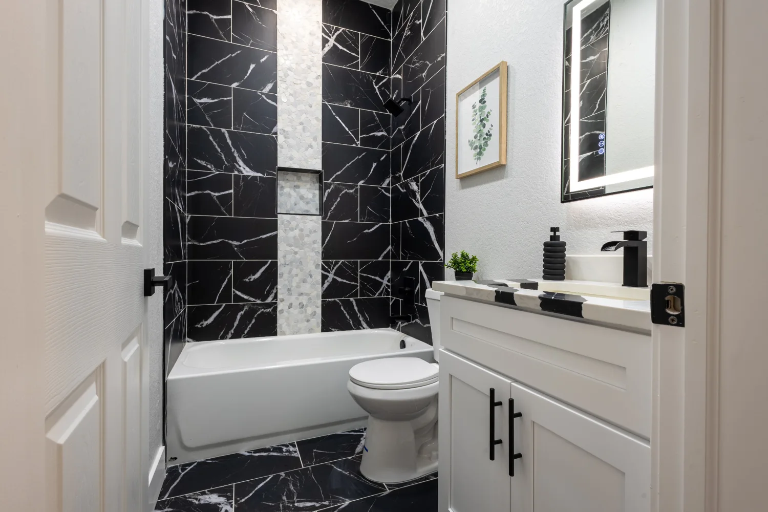 Black tile shower and freestanding bathtub