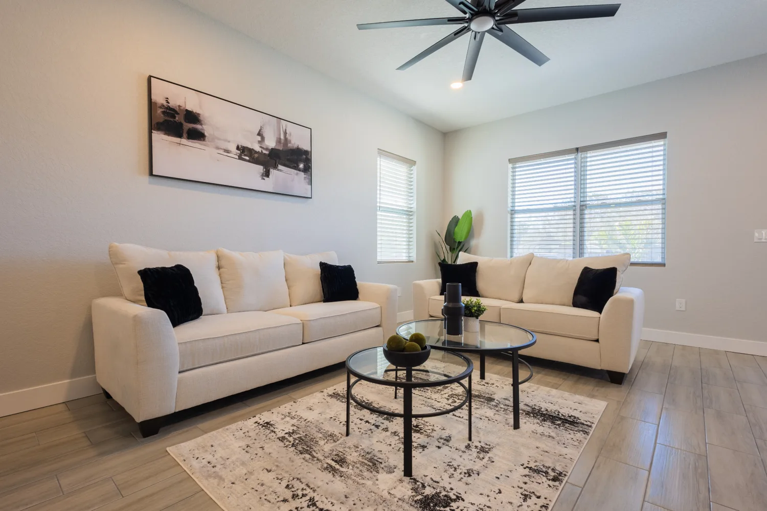 Bright, neatly arranged living room with neutral furnishings